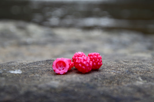 Pink Steelhead beads, with a scent chamber siting on a rock